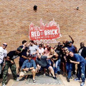 group infront of red brick brewery on tour