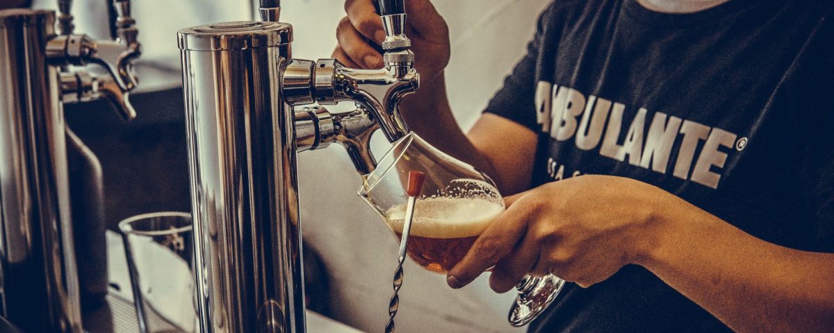 man pouring draft beer