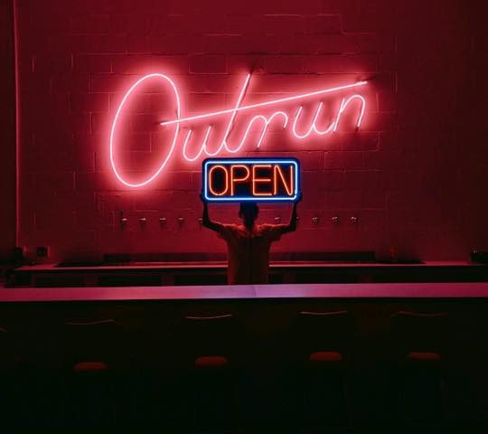 neon sign "open" for outrun brewing